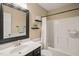 Bathroom features a sink with dark cabinets, mirror and a tub and shower with white tile at 6324 Daybreak Dr, Wake Forest, NC 27587