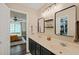 Modern bathroom with double vanity, stylish lighting, and access to a walk-in closet at 6324 Daybreak Dr, Wake Forest, NC 27587