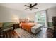 Cozy bedroom with a ceiling fan, area rug, and a comfortable bed with lamps at 6324 Daybreak Dr, Wake Forest, NC 27587