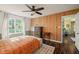 Charming bedroom with wood paneling and a large window providing ample natural light at 6324 Daybreak Dr, Wake Forest, NC 27587