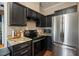 Kitchen with black cabinets, granite countertops, and stainless steel refrigerator at 6324 Daybreak Dr, Wake Forest, NC 27587