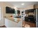 Well-equipped kitchen with dark cabinets, granite countertops, and stainless steel appliances at 6324 Daybreak Dr, Wake Forest, NC 27587