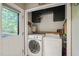 Bright laundry room with washer, dryer, cabinets, and access to the backyard at 6324 Daybreak Dr, Wake Forest, NC 27587