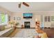 Comfortable living room boasts a fireplace, hardwood floors, and a view into the bedroom at 6324 Daybreak Dr, Wake Forest, NC 27587