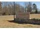 E. Carroll Joyner Park sign with stone base and surrounding landscape along the road at 6324 Daybreak Dr, Wake Forest, NC 27587