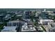 An aerial view shows a developed downtown area with mature trees, various architecture, and light traffic at 6509 Mountain Brook Ln, Raleigh, NC 27615