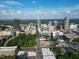 An aerial view displays a downtown area with mature trees, multiple office buildings, and some residential architecture at 6509 Mountain Brook Ln, Raleigh, NC 27615