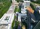 An aerial view shows community amenities, surrounding architecture, and green spaces in an urban neighborhood at 6509 Mountain Brook Ln, Raleigh, NC 27615
