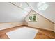 Attic space featuring hardwood floors and white walls and ceiling at 6509 Mountain Brook Ln, Raleigh, NC 27615