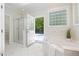 Bathroom including a shower, soaking tub, and access to a private outdoor swimming pool at 6509 Mountain Brook Ln, Raleigh, NC 27615