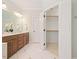 Bathroom featuring double sink vanity, decorative lighting, and large walk-in closet at 6509 Mountain Brook Ln, Raleigh, NC 27615
