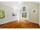 A well-lit room with hardwood floors and ample natural light from several windows at 6509 Mountain Brook Ln, Raleigh, NC 27615