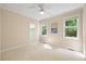 A cozy bedroom with neutral walls, plush carpeting, and ample natural light from the windows at 6509 Mountain Brook Ln, Raleigh, NC 27615