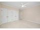A large room with plush carpet, a ceiling fan, and closet space at 6509 Mountain Brook Ln, Raleigh, NC 27615