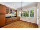 Dining area featuring hardwood floors and large windows overlooking the backyard at 6509 Mountain Brook Ln, Raleigh, NC 27615