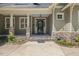 Inviting front entrance with stone pillars, landscaping, and a modern black front door at 6509 Mountain Brook Ln, Raleigh, NC 27615