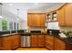 Kitchen featuring stainless steel appliances, granite counters, and wooden cabinets at 6509 Mountain Brook Ln, Raleigh, NC 27615