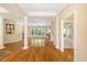 Spacious living room featuring hardwood floors, elegant columns, and an abundance of natural light at 6509 Mountain Brook Ln, Raleigh, NC 27615