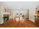 Open-concept living room with fireplace, hardwood floors, and views into the dining area at 6509 Mountain Brook Ln, Raleigh, NC 27615
