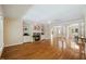Open-concept living room with fireplace, hardwood floors, and views into the dining area at 6509 Mountain Brook Ln, Raleigh, NC 27615