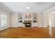 Open living space with built-in shelving, a stone fireplace, and hardwood floors at 6509 Mountain Brook Ln, Raleigh, NC 27615