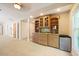 Entertainment room features a custom built-in bar with a sink and compact refrigerator at 6509 Mountain Brook Ln, Raleigh, NC 27615