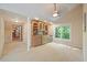 Open living room featuring a built-in bar, plush carpet flooring, and a view to the backyard at 6509 Mountain Brook Ln, Raleigh, NC 27615