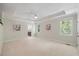 A spacious main bedroom with a tray ceiling, plush carpeting, and natural light from two windows at 6509 Mountain Brook Ln, Raleigh, NC 27615