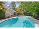 Gorgeous in-ground pool with a patio and swing outside of this single-Gathering home surrounded by lush trees at 6509 Mountain Brook Ln, Raleigh, NC 27615