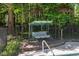 Relaxing outdoor patio swing near an in-ground pool and lush backyard that is great for entertaining at 6509 Mountain Brook Ln, Raleigh, NC 27615
