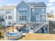 This backyard has a deck, a gazebo with outdoor seating, and a small water feature all on a manicured lawn at 6633 Penfield St, Wake Forest, NC 27587