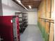 Unfinished basement storage room with shelving and painted floor at 6633 Penfield St, Wake Forest, NC 27587