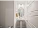 A pristine powder room showcasing a pedestal sink, oval mirror, and modern fixtures at 6633 Penfield St, Wake Forest, NC 27587