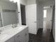 Bathroom featuring double vanity, marble countertop, modern finishes and black tiled floor at 6633 Penfield St, Wake Forest, NC 27587