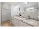 Bright bathroom showcasing double sinks with granite counters, a tiled shower, and modern fixtures at 6633 Penfield St, Wake Forest, NC 27587