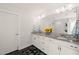Bathroom featuring double vanity with granite countertop and large mirror at 6633 Penfield St, Wake Forest, NC 27587