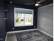 Stylish bedroom with modern colors, wood-look flooring, and view to houses outside the window at 6633 Penfield St, Wake Forest, NC 27587