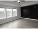 Bedroom with laminate floors and natural light from the triple window at 6633 Penfield St, Wake Forest, NC 27587