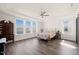 Primary bedroom featuring lots of light, a tray ceiling, and hardwood floors at 6633 Penfield St, Wake Forest, NC 27587