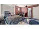 Bedroom featuring an exposed brick wall, wood floors, and stylish decor at 6633 Penfield St, Wake Forest, NC 27587