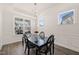 Elegant dining room featuring tray ceiling, modern chandelier, and large windows providing natural light at 6633 Penfield St, Wake Forest, NC 27587