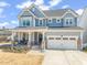 Inviting two story home featuring a charming front porch and manicured lawn at 6633 Penfield St, Wake Forest, NC 27587