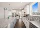 Modern kitchen featuring a large island with seating, stainless steel appliances, and stylish white cabinetry at 6633 Penfield St, Wake Forest, NC 27587