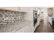 Close-up of granite counters and white cabinets; stainless double ovens offer modern cooking convenience at 6633 Penfield St, Wake Forest, NC 27587