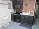 Basement kitchen with appliances and brick backsplash at 6633 Penfield St, Wake Forest, NC 27587