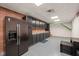 Large kitchen with dark cabinets, stainless steel refrigerator, brick accents and unique ceiling at 6633 Penfield St, Wake Forest, NC 27587