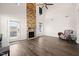 Bright living room showcasing a stone fireplace, high ceilings, and a cozy chair at 6633 Penfield St, Wake Forest, NC 27587