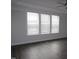 Bright living room with hardwood floors and a row of windows at 6633 Penfield St, Wake Forest, NC 27587