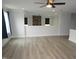 Open-concept living area with hardwood floors, large windows, and modern finishes at 6633 Penfield St, Wake Forest, NC 27587