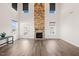 Spacious living room with a stone fireplace, soaring ceilings, and access to outdoor deck at 6633 Penfield St, Wake Forest, NC 27587